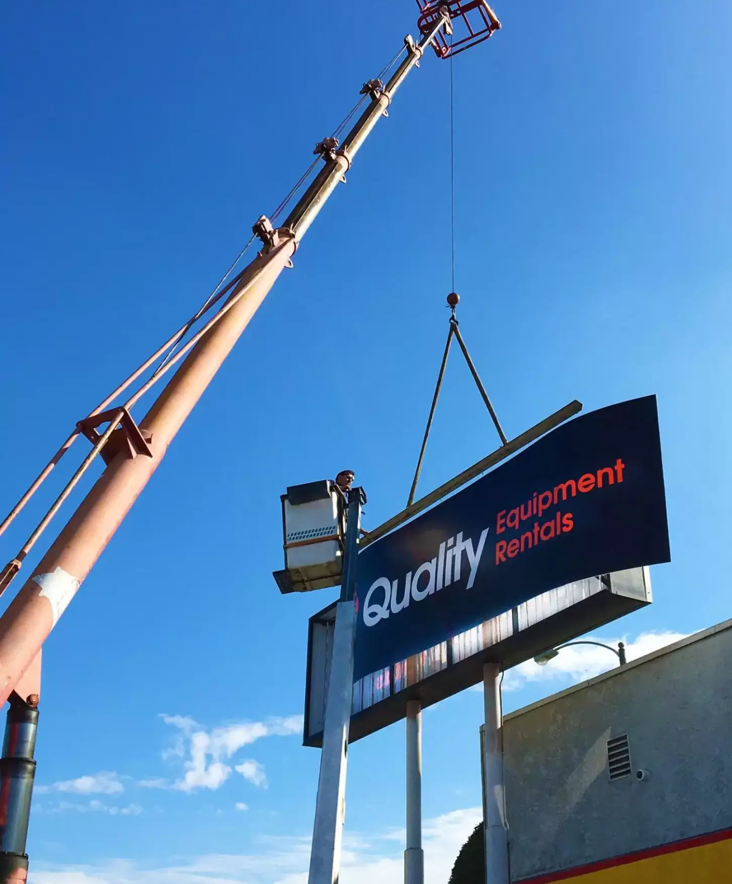 Crew installing channel letters on a building façade
